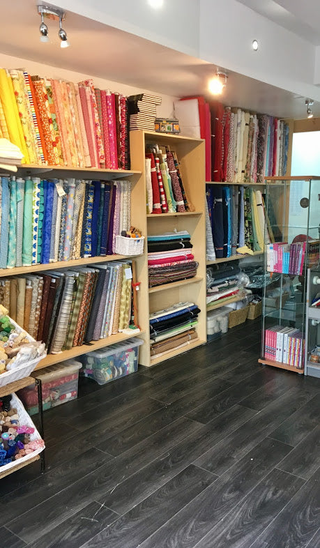 shelves of cotton fabrics in many colours and designs