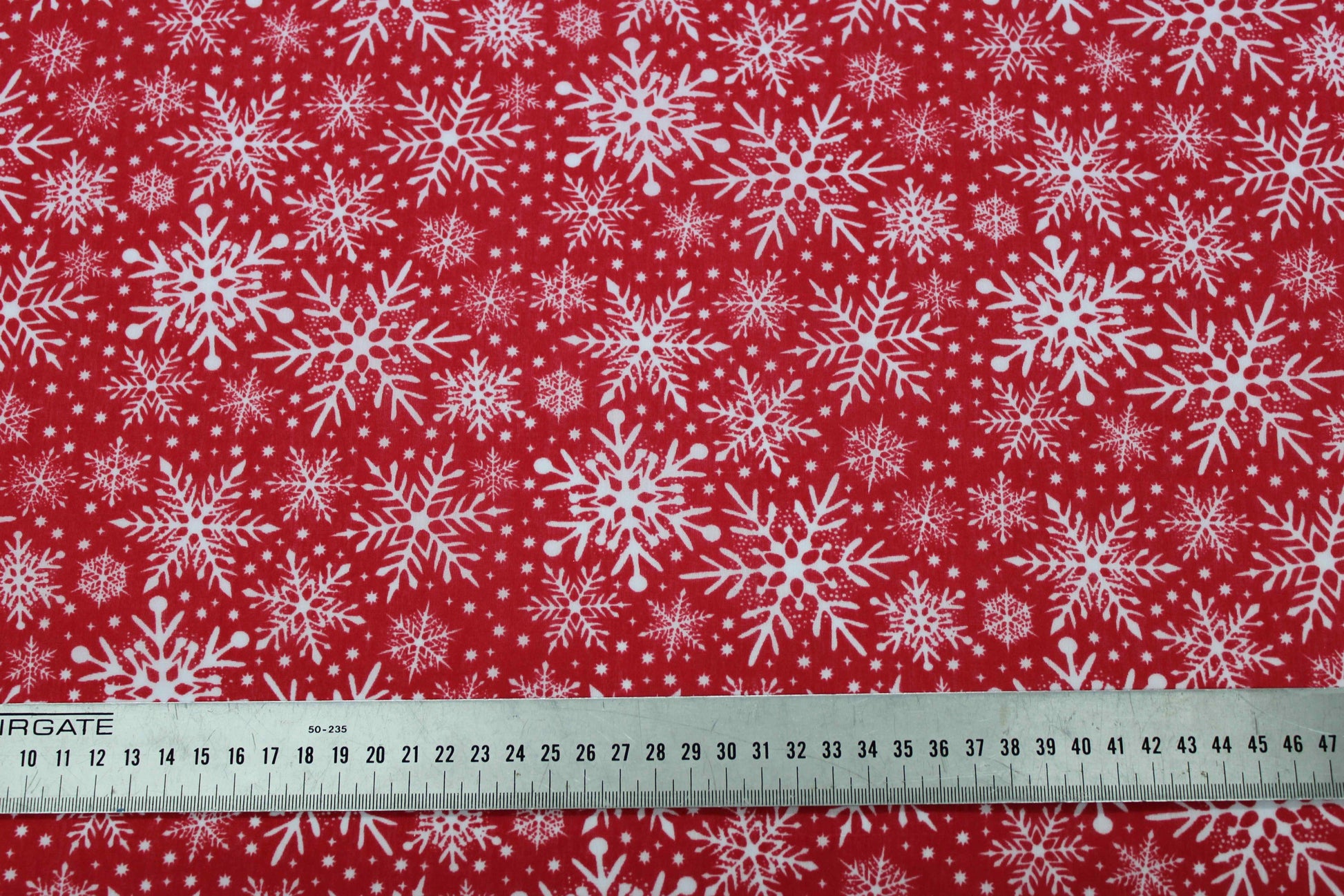 various white snowflake designs on red fabric