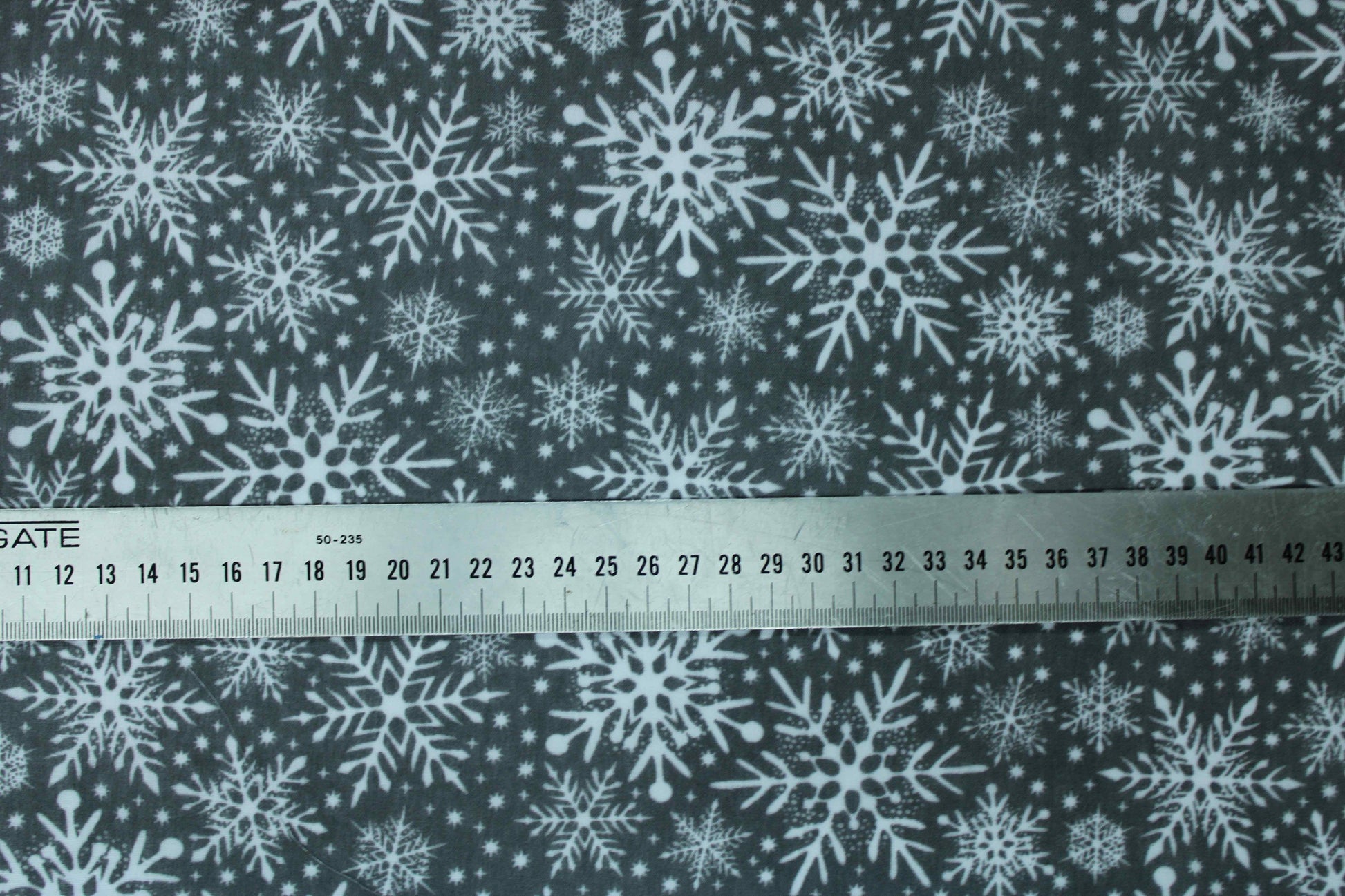 Various white snowflake designs on grey fabric