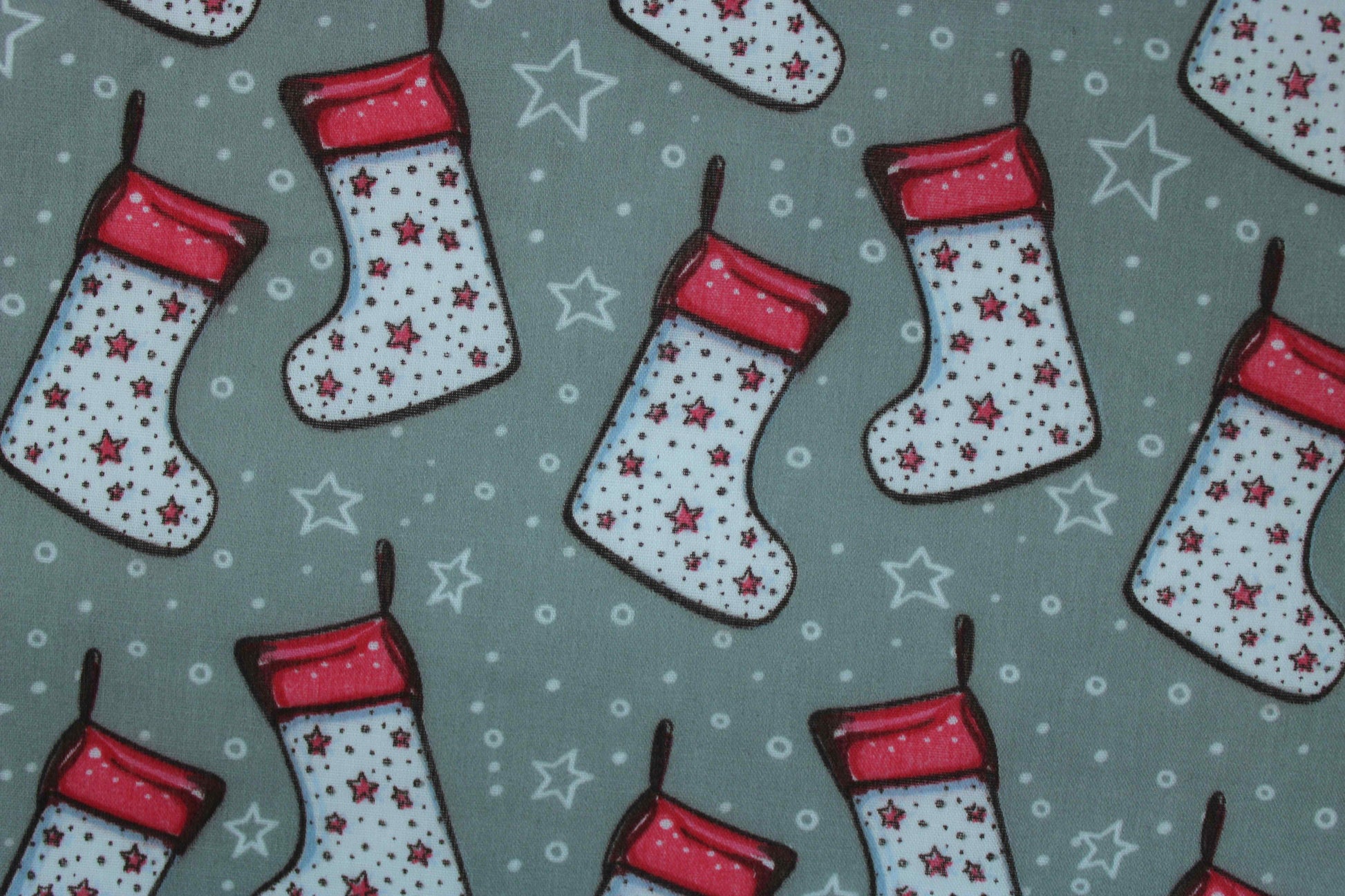white christmas stocking design on grey fabric with star and dots detail fabric