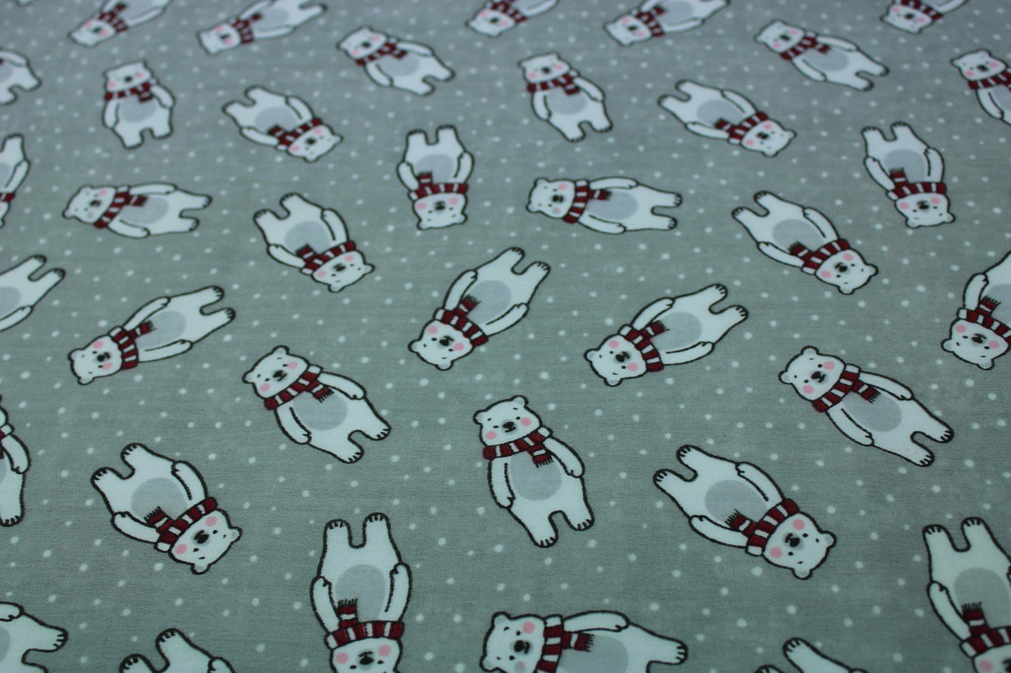 polar bear with red scarf on pale grey background with dots detail fabric