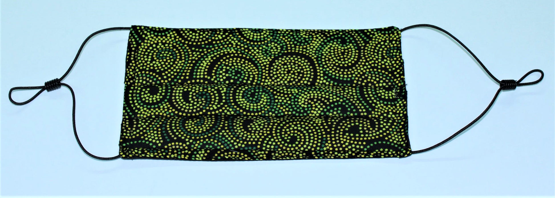folded facemask with green ethnic dot painted swirl design