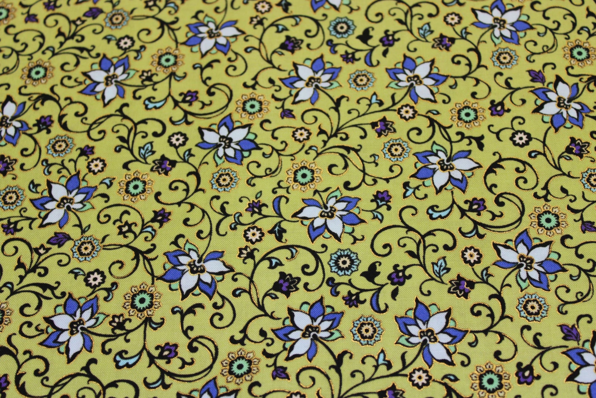 goldedged cotton flower print in blues on green