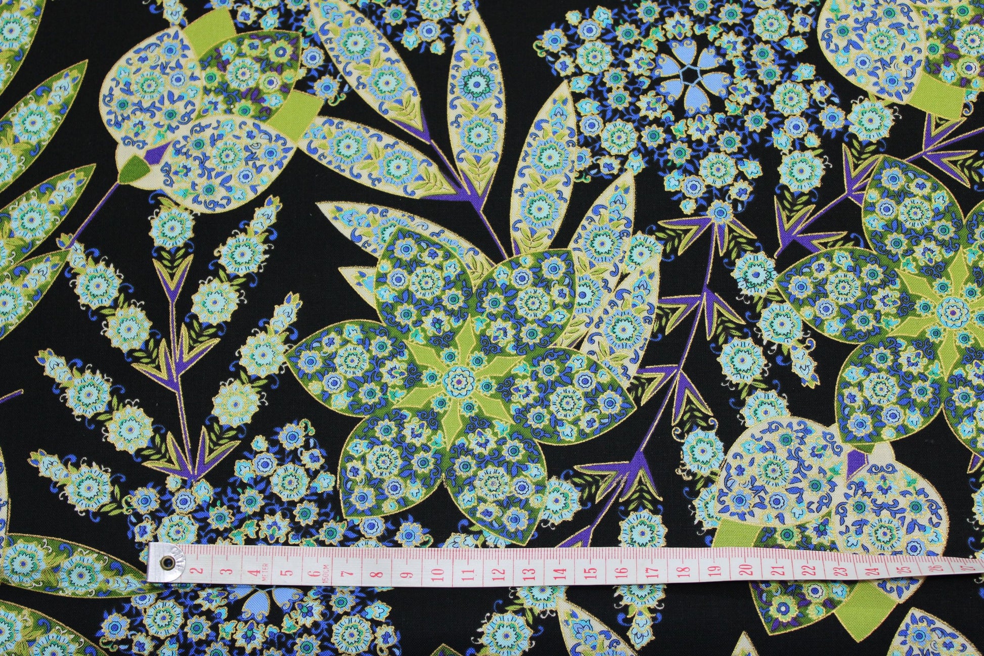 goldedged fantasy flowers in blues, greens and purple on black