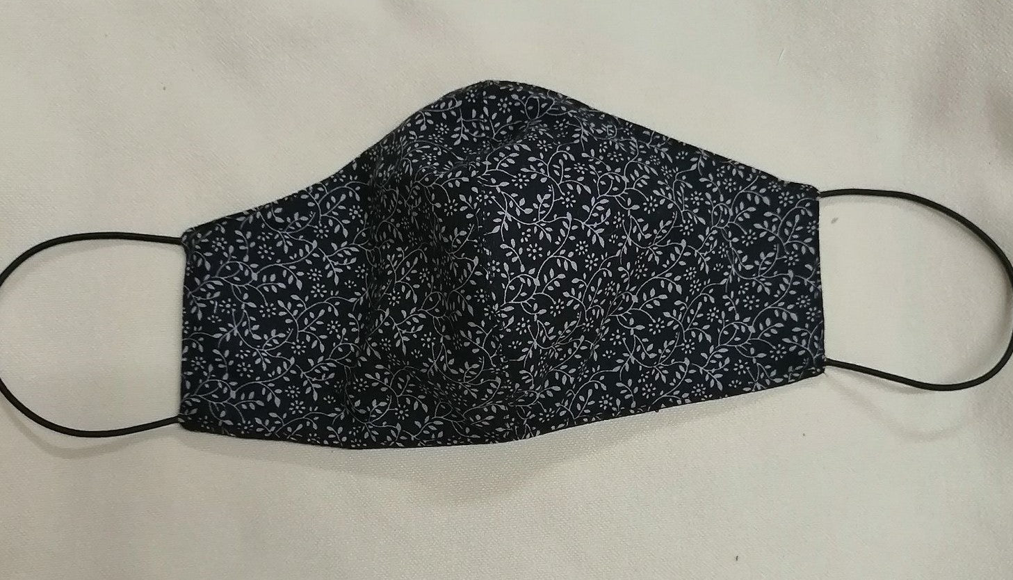 shaped facemask in black and white  ditzy lieaf design